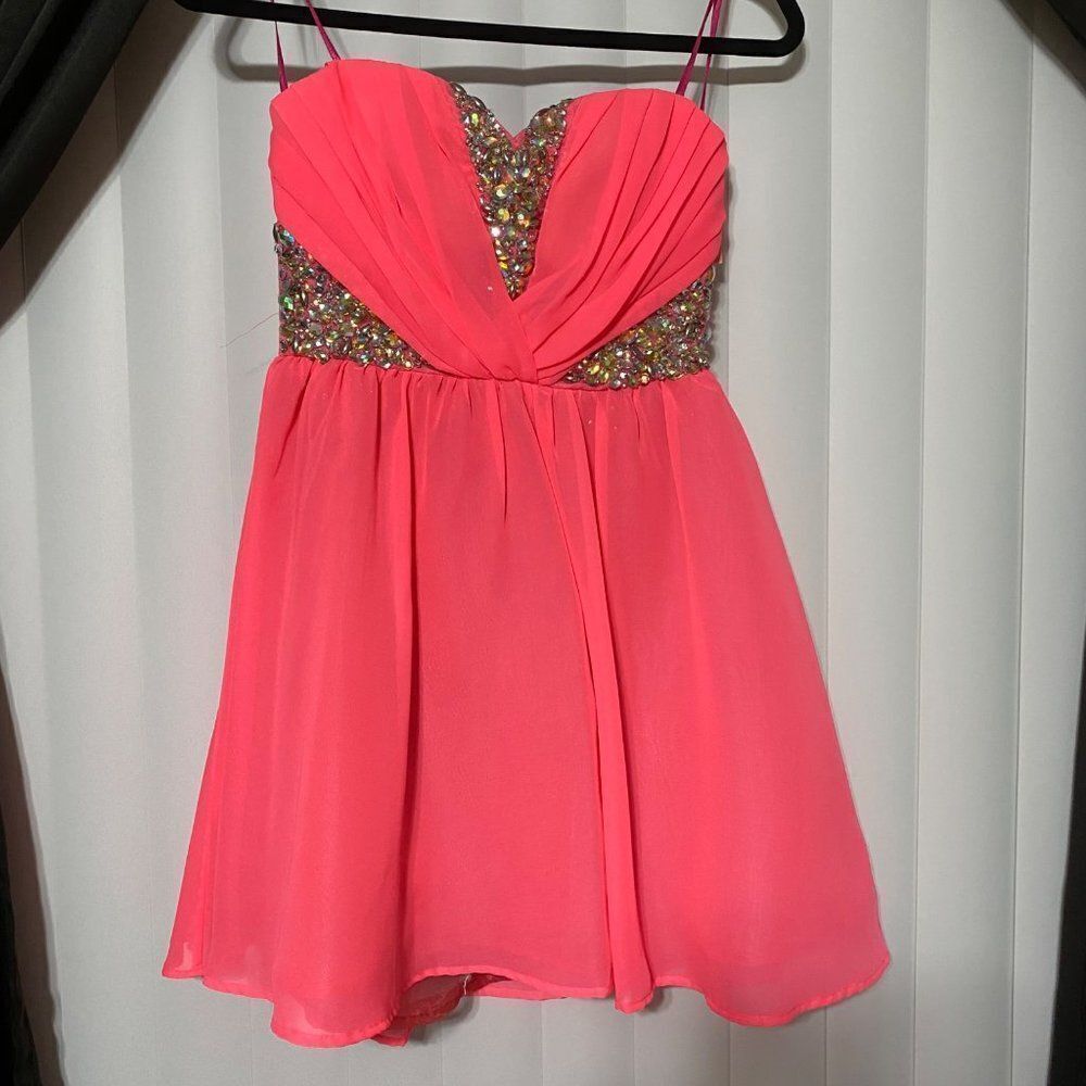Bright pink, homecoming dress! Front: wavy by the chest, sliver design and holog